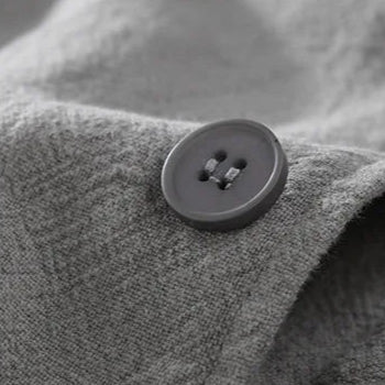 Close-up of a heavy-duty button on a gray Element Linen Hoodie showcasing quality craftsmanship.