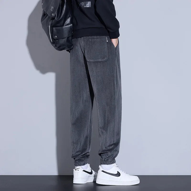 Men's tapered checkered corduroy pants in gray, featuring an adjustable waistband and cuffed hems for comfort.