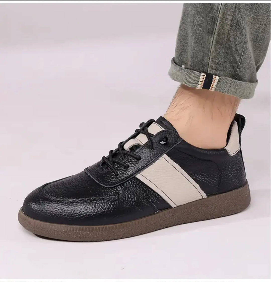 Axel Street Comfort Sneakers in black leather with beige side panels and cushioned sole, perfect for stylish, all-day wear.