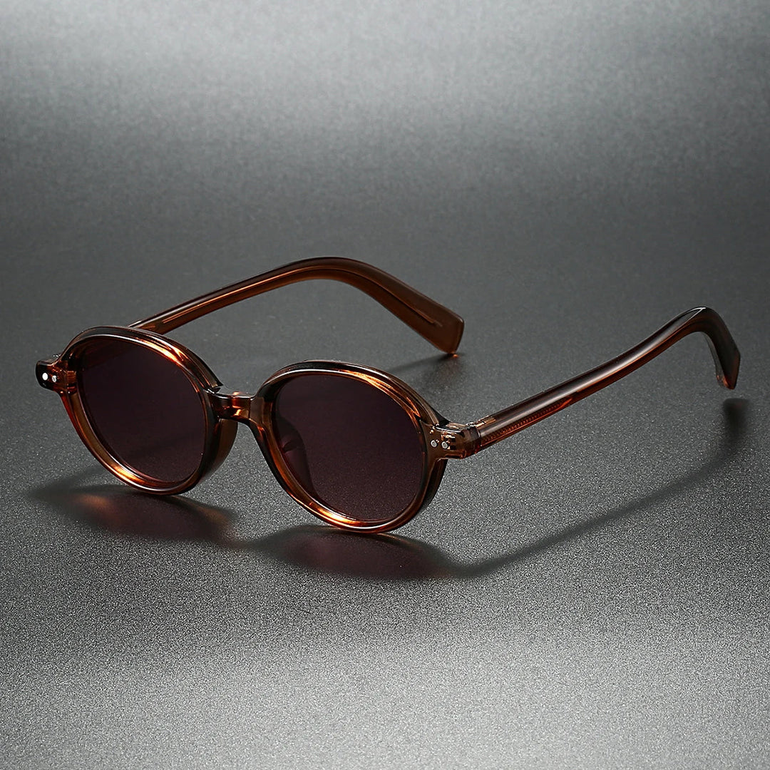 Sable round sunglasses with thick acetate frames and UV400 gradient lenses on a dark surface.