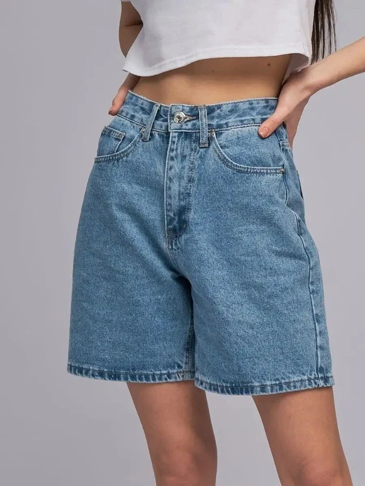 Model wearing Lyra Vintage High Waist Denim Shorts, showcasing a classic straight-leg cut and subtly washed denim finish.