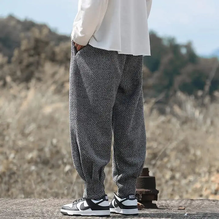 Oslo Textured Joggers featuring a relaxed fit and rich woven design, paired with sneakers in an outdoor setting.