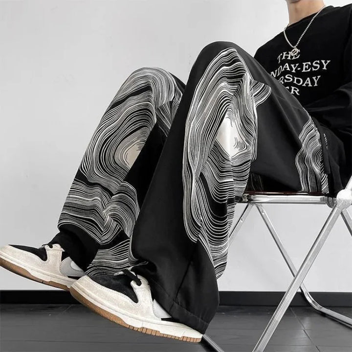 Vortex Ripple Pants featuring abstract print, wide-leg design, and adjustable drawstring waist, offering fluid movement.
