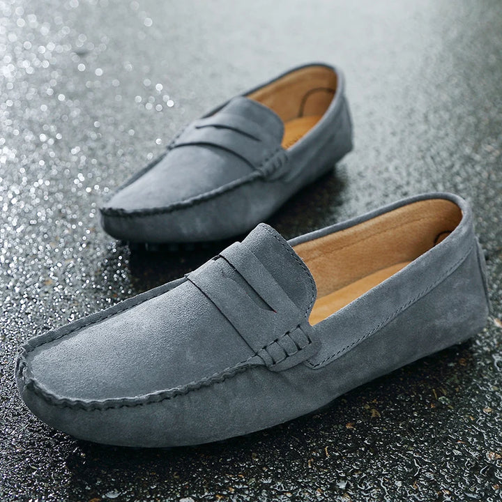 Grazia Suede Loafers in gray with a soft cow suede upper, featuring precision hand-stitching and a flexible rubber sole.