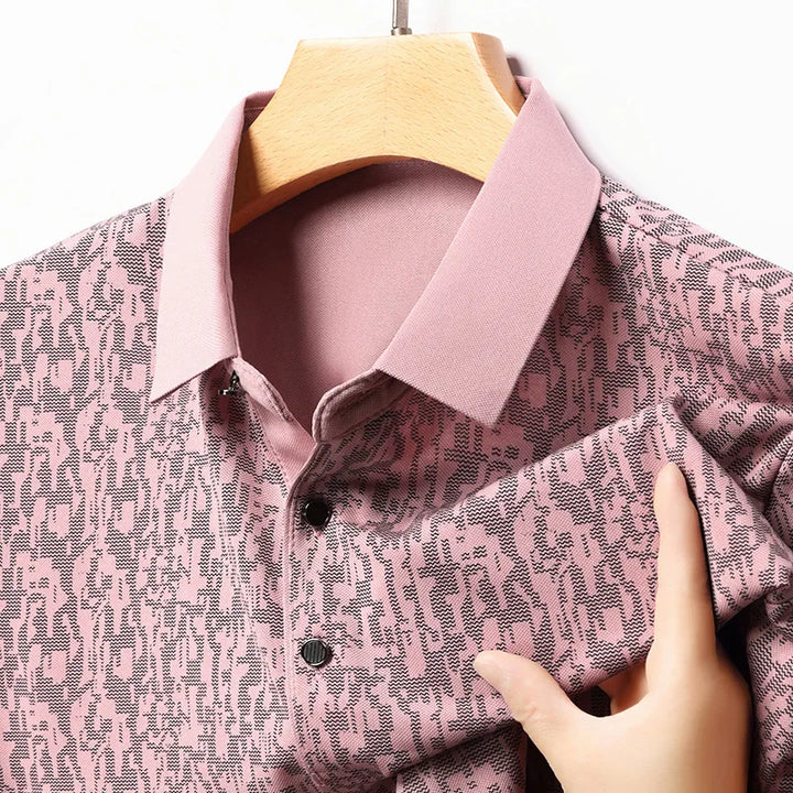 Close-up of Auren Men's Jacquard Polo Shirt showcasing its textured fabric and structured collar in pink.