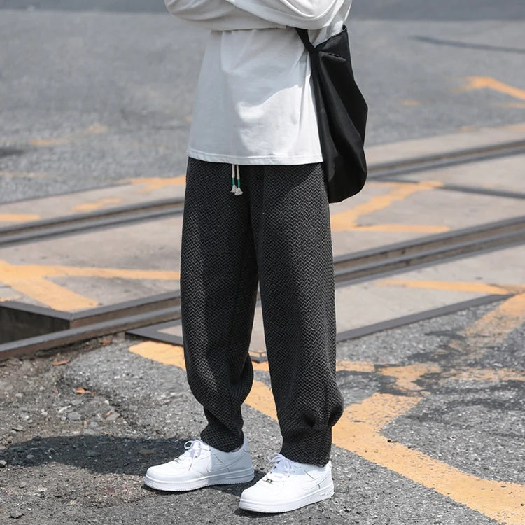Oslo textured joggers featuring a relaxed fit and tapered cuffs, styled with a casual shirt and sneakers.