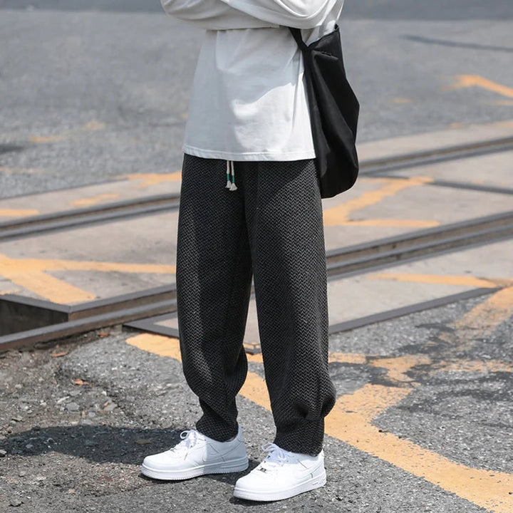 Oslo textured joggers featuring a relaxed fit and tapered cuffs, styled with a casual shirt and sneakers.