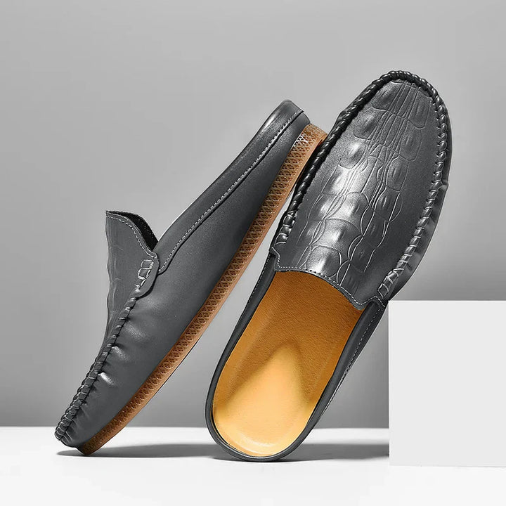 Gianni Backless Slide Loafers in black with embossed texture and classic moc toe for effortless style and comfort.