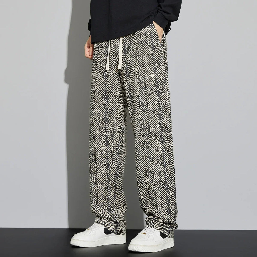 Lennox cotton linen pants in a relaxed fit with herringbone texture, featuring adjustable drawstring and paired with white sneakers.