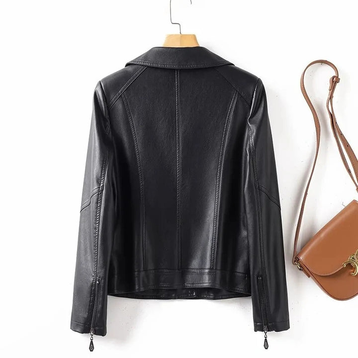 Black leather jacket on a hanger with a brown handbag on a white background