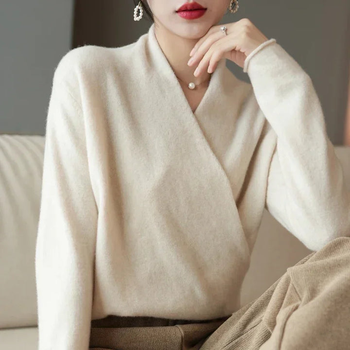 Elegant wrap-front wool sweater in cream, showcasing a relaxed fit, perfect for luxurious comfort and style.