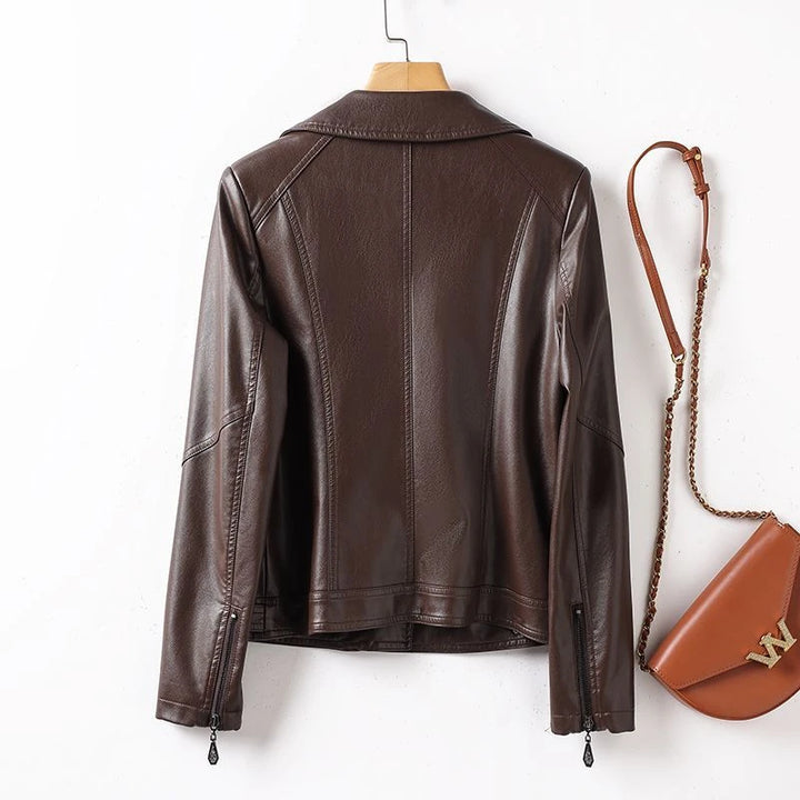 Brown leather jacket on a hanger with a matching handbag on a white background