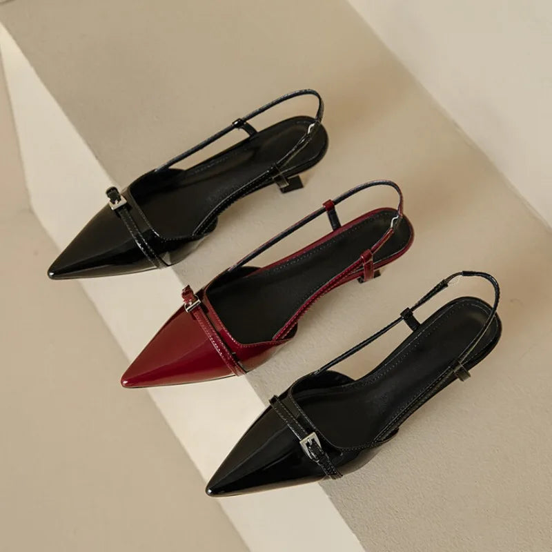 Slingback heels in black and red with pointed toes and adjustable straps, showcasing a glossy shine and stylish design.