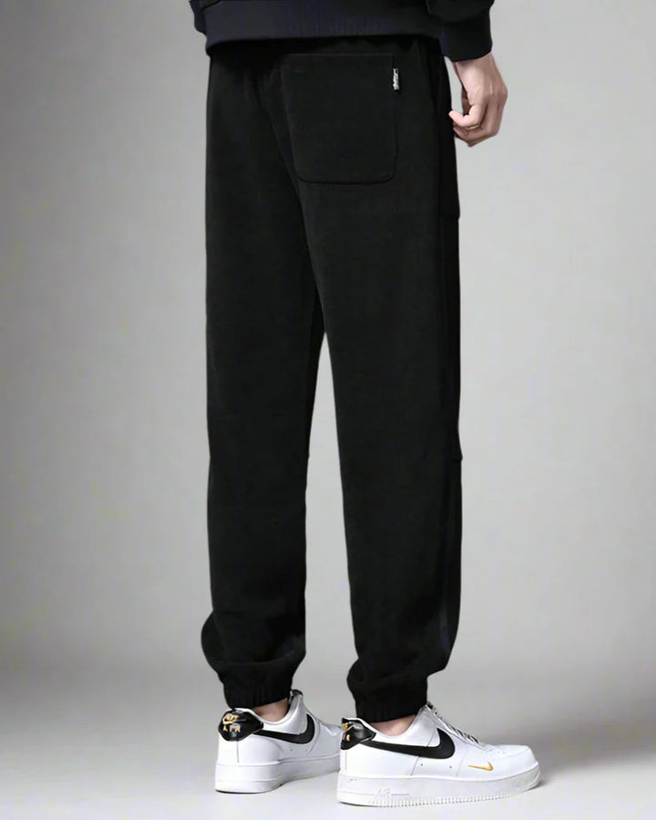 Black Amos Corduroy Joggers featuring a relaxed tapered fit and large pockets for casual style.