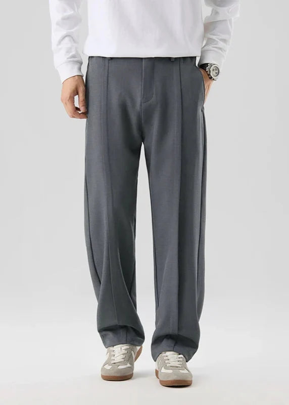 Calloway pleated trousers in gray with a relaxed straight-leg fit, featuring a pleated front and tailored waistband.