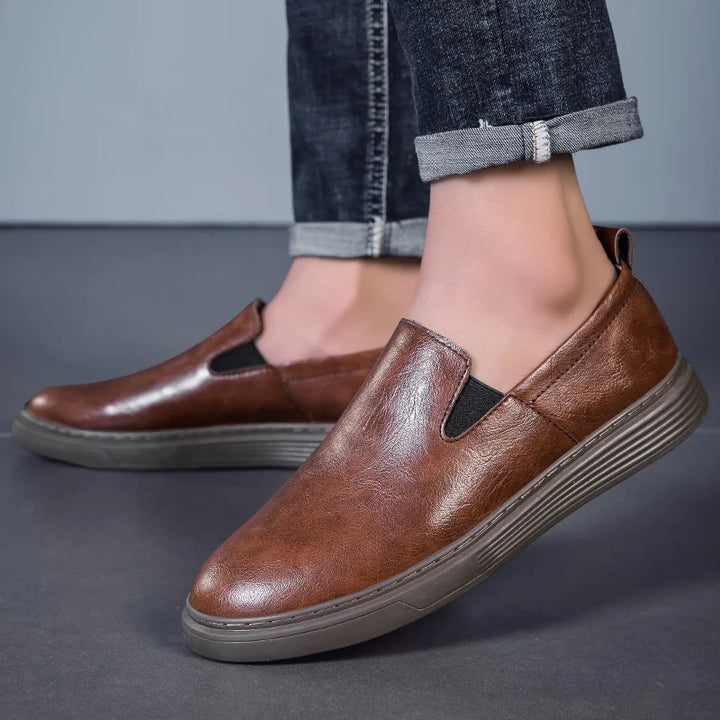 Duke Leather Slip-On Shoes in brown, featuring a cushioned sole and elastic side panels for comfortable wear.