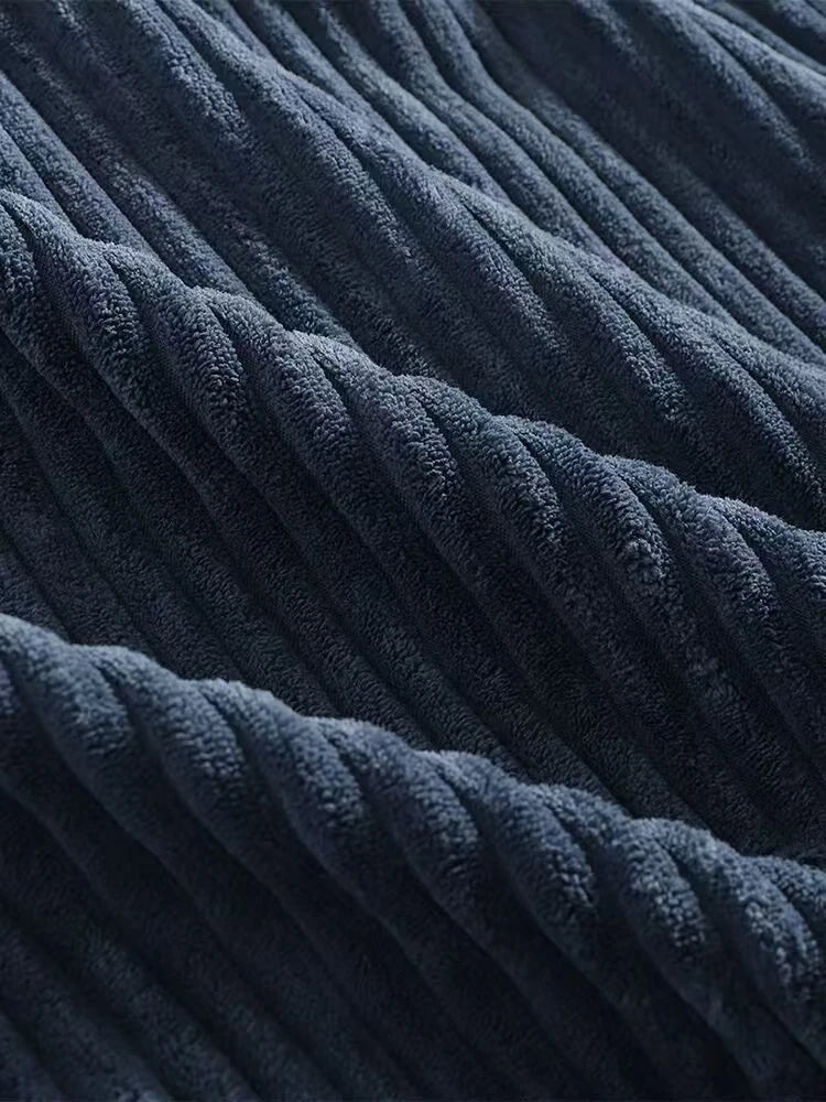 Close-up of premium navy corduroy fabric showcasing rich ribbed texture and soft feel.