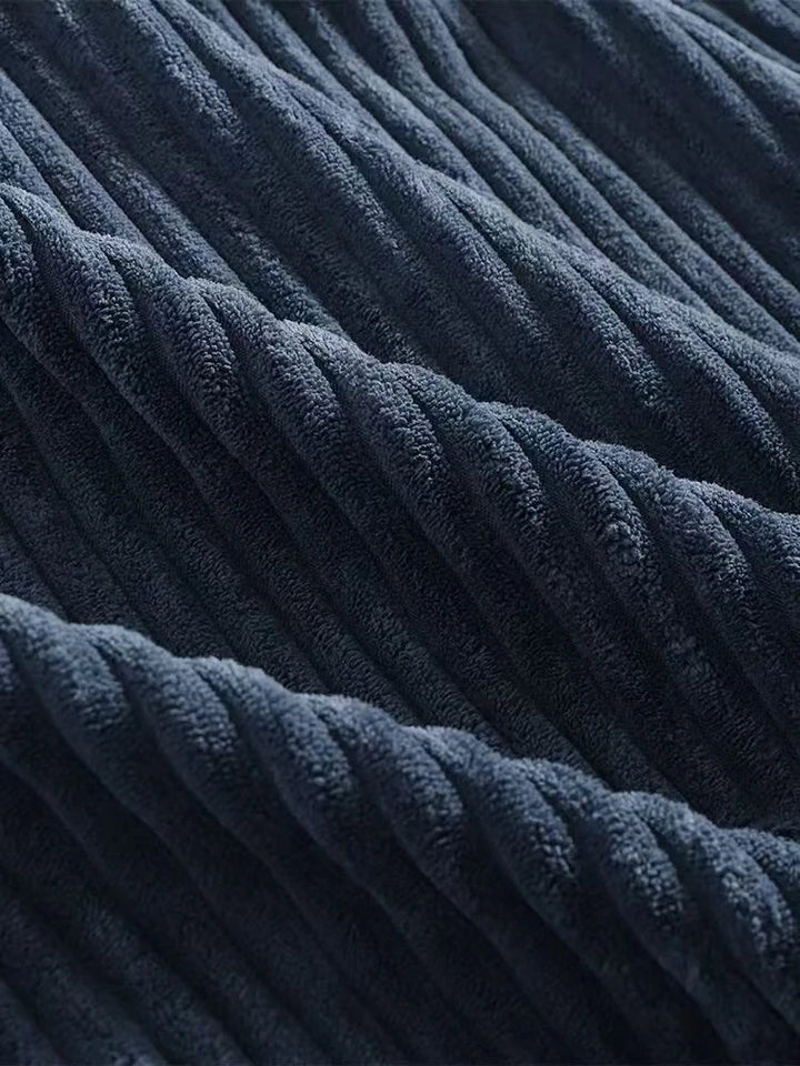 Close-up of premium navy corduroy fabric showcasing rich ribbed texture and soft feel.