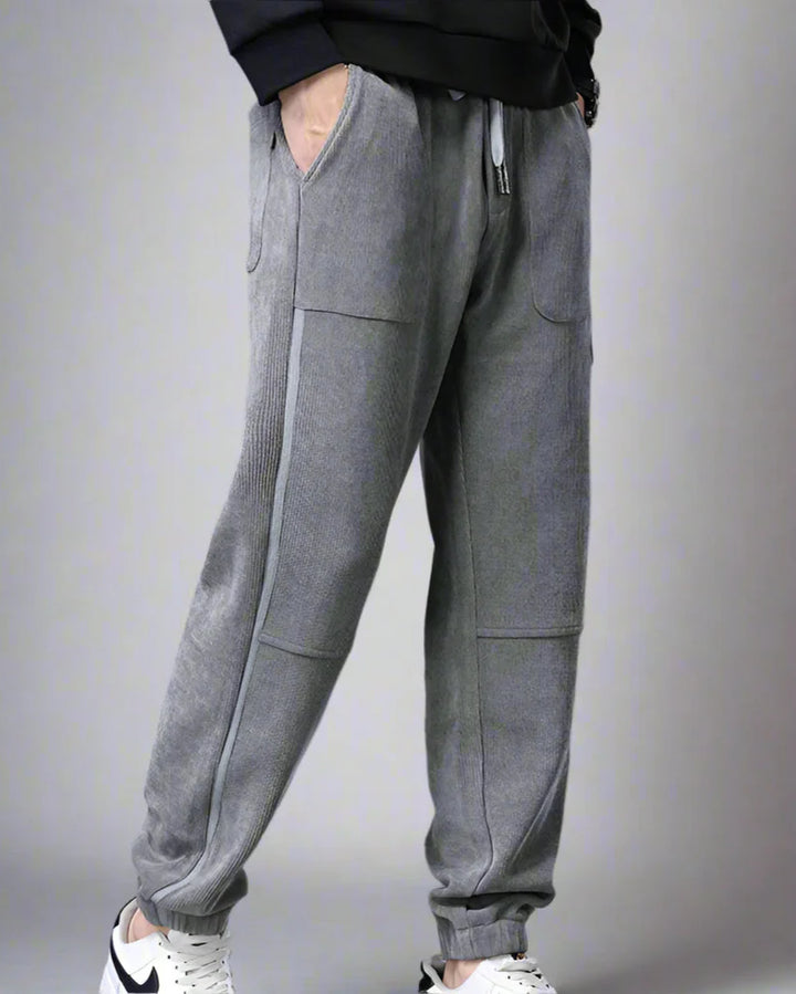 Amos Corduroy Joggers in gray with spacious pockets and tapered fit, showcasing wide-wale corduroy texture.