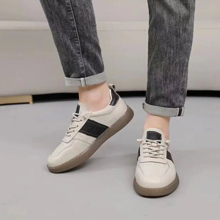 Axel Street Comfort Sneakers in beige and black, showcasing genuine leather construction and cushioned sole.