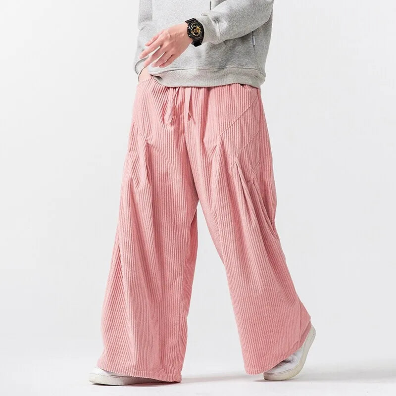 Hollis Corduroy Pants in pink, wide-leg style with deep pleats and elastic waistband for a bold, comfortable fit.