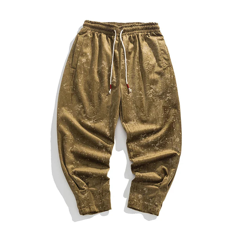 Crushed velvet joggers in a relaxed fit with elastic cuffs and drawstring waist, showcasing a bold sheen and textured finish.