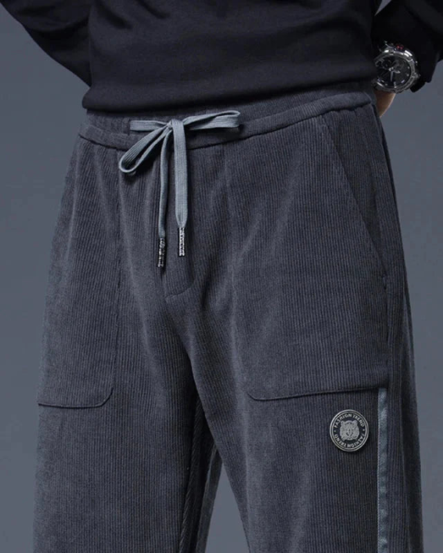 Close-up of Amos Corduroy Joggers featuring a relaxed tapered fit, adjustable drawstring waist, and large pockets.