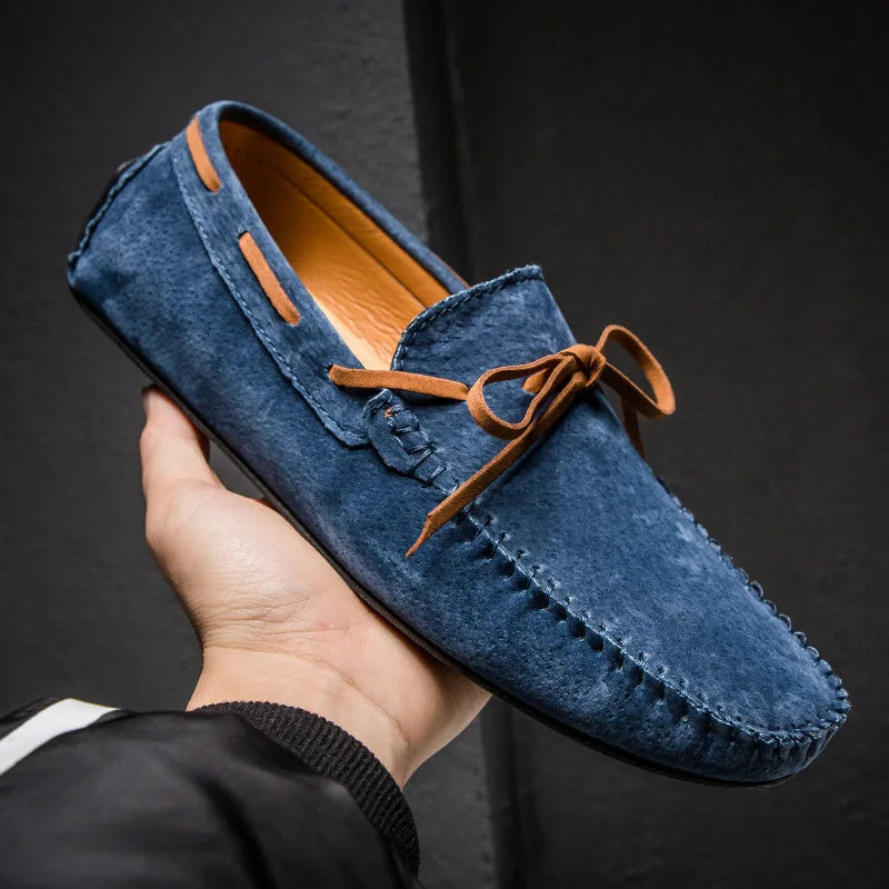 Monte Carlo genuine suede loafers in blue with leather laces, showcasing hand-stitched craftsmanship and slip-on design.
