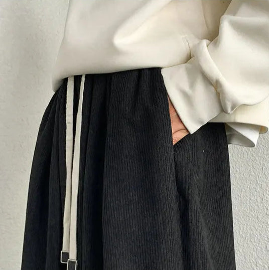 Close-up view of Arlo corduroy pants featuring adjustable drawstring waist and deep pocket.