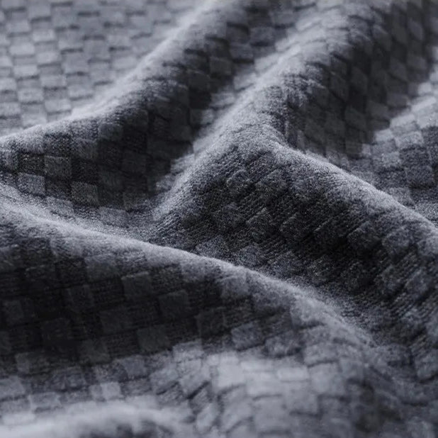 Close-up of checkered corduroy fabric showcasing rich texture and softness, perfect for Riden Checkered Corduroy Pants.
