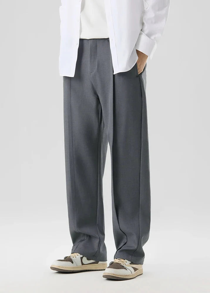 Calloway pleated trousers in grey, featuring a relaxed straight-leg design and elegant pleated front for comfort and style.
