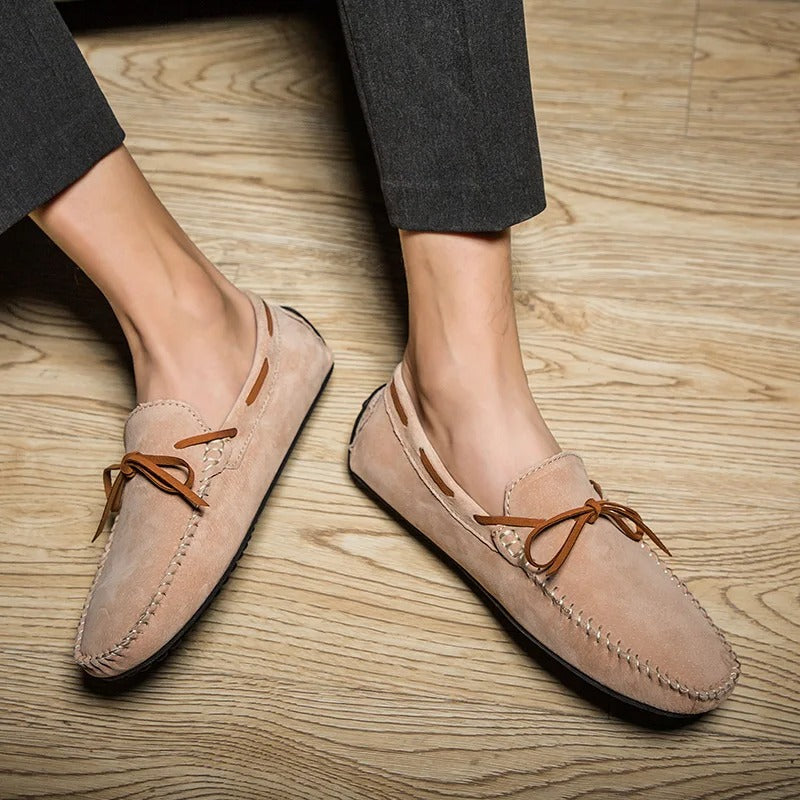 Monte Carlo genuine suede loafers with hand-stitched details and premium leather laces on a wooden floor.