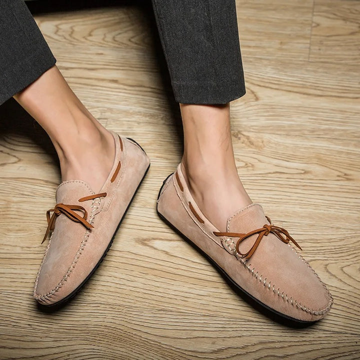 Monte Carlo genuine suede loafers with hand-stitched details and premium leather laces on a wooden floor.