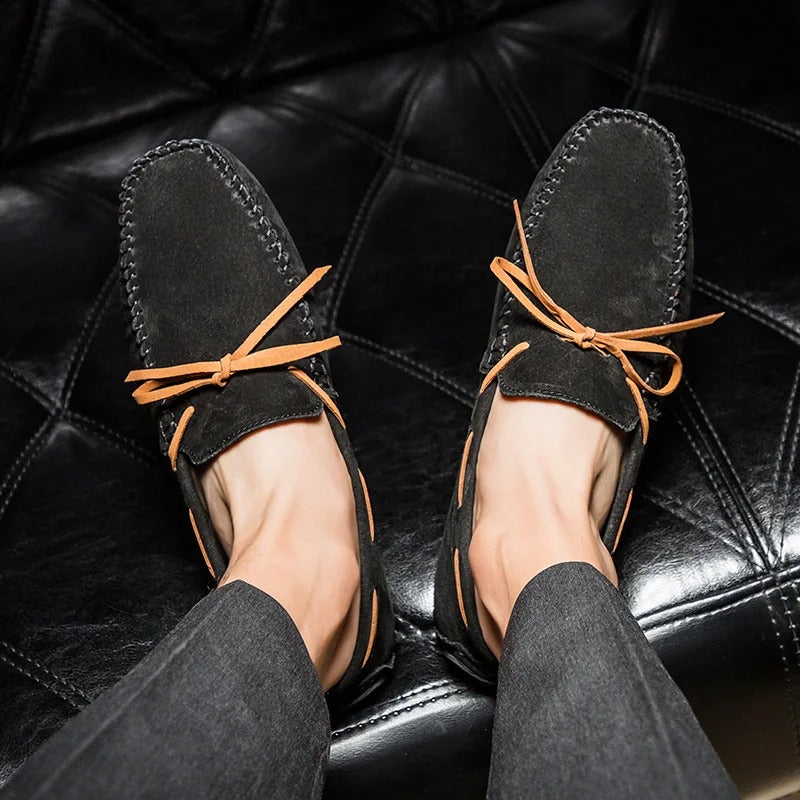 Monte Carlo genuine cowhide suede loafers with hand-stitched details and premium leather laces, showcased in a stylish setting.