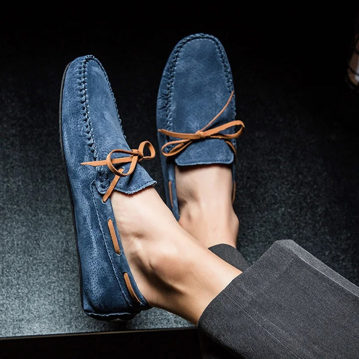 Monte Carlo genuine suede loafers in blue with brown leather laces, showcasing hand-stitched detailing and slip-on design.