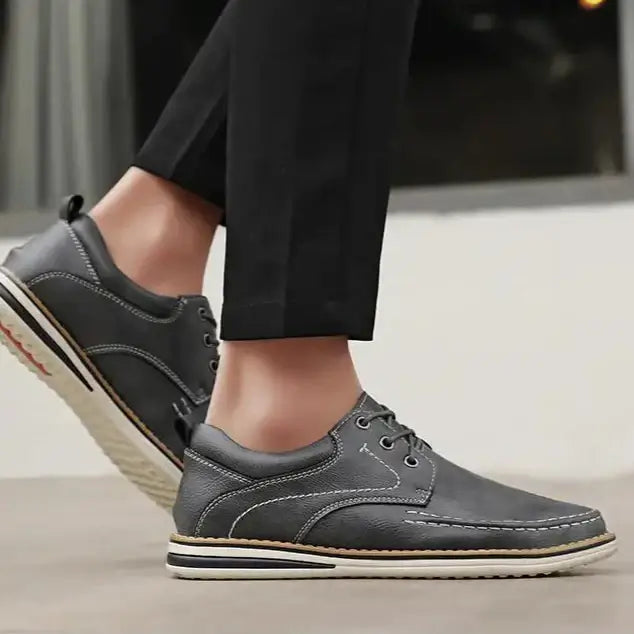Luciano Genuine Leather Oxfords in grey, featuring lace-up design, contrast stitching, and cushioned collar for comfort.