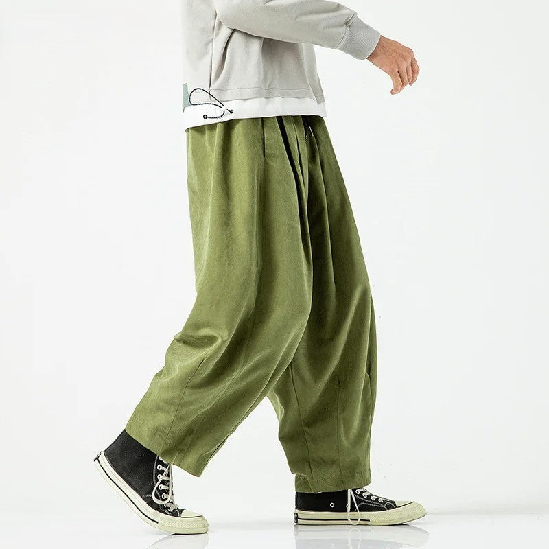 Cove Park Relaxed Pants in olive green, wide-leg silhouette, paired with a casual grey sweatshirt and sneakers.