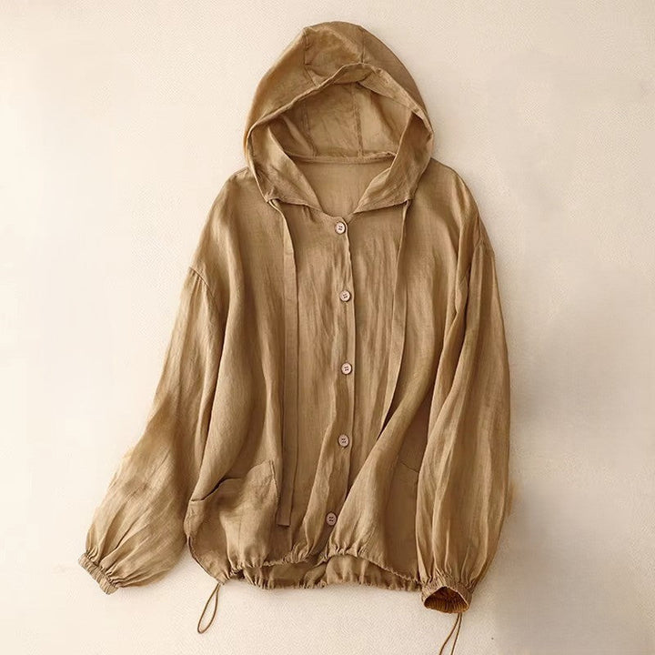 Calypso Coast linen hoodie in beige with adjustable drawstring hem and button-up front for casual sunny day wear.