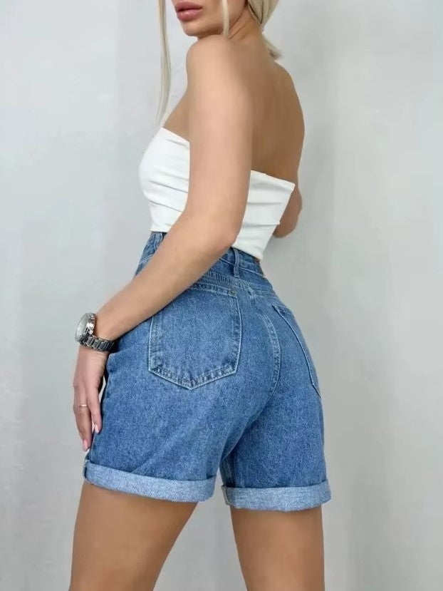 Model wearing Bella Y2K High Waist Jean Shorts with rolled cuffs, showcasing vintage-inspired denim style.